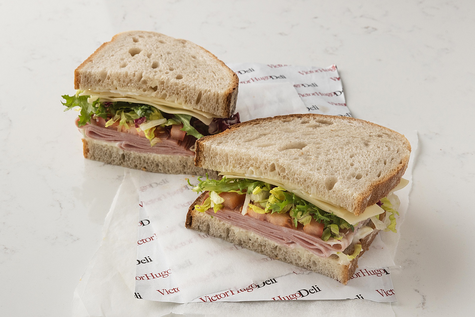 New York style pastrami rye sandwich on white marble